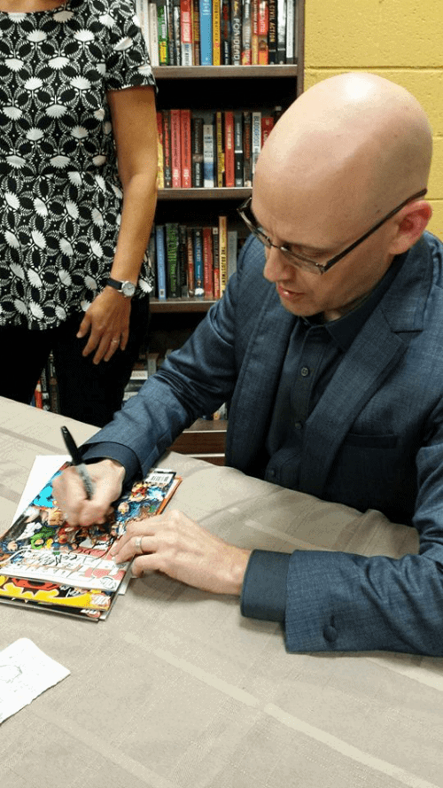 Brad Meltzer, author of Justice League comics and graphic novels, the Ordinary Heroes children's book series and political thrillers, signs our books at an author event at Flyleaf Books.