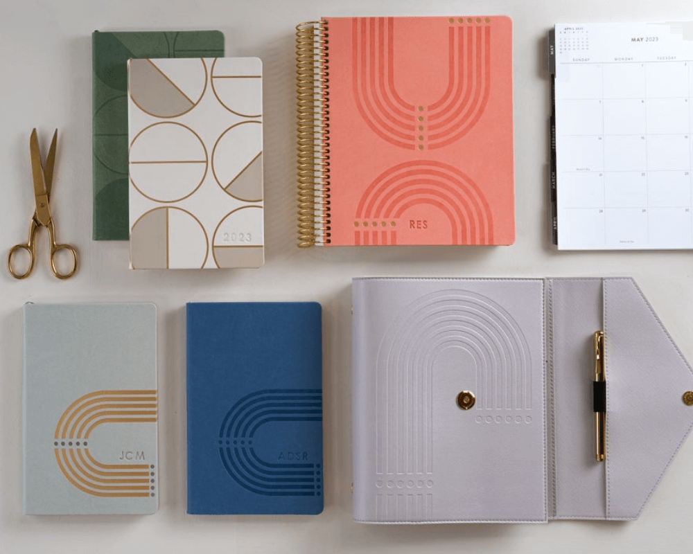 erin condren focused collection planners, various planners shown in neutral colors and coilbound, ring agenda and softbound planners