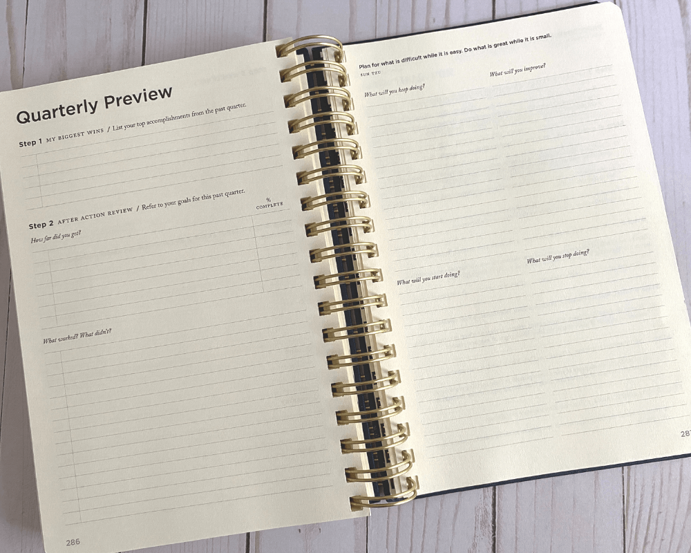 full focus planner review - wire bound planner with cream colored paper is open to the quarterly preview pages with questions and lines for responses